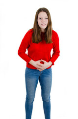 Teenage girl with stomach ache. Adorable little girl with hand on stomach because indigestion, painful illness feeling unwell. Ache concept. Abdominal cramps. Isolated on white background
