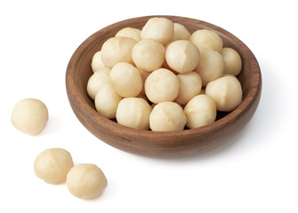 Shelled Macadamia nuts in the wooden bowl, isolated on white background.