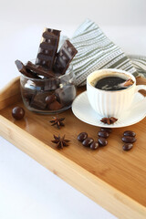 White mug with freshly brewed coffee and lots of chocolate. Sweet breakfast. Selective focus. Vertical photo.
