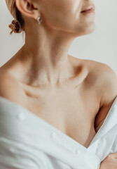 Close-up of a young woman's neck, collarbone, chest. Lines on the neck. Wrinkles, age-related...