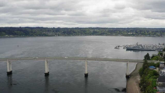 Manette Bridge Spanning Port Washington Narrows With Puget Sound Naval Shipyard In The Background At Bremerton, Washington In USA. - aerial