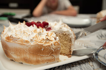 person slicing a cake