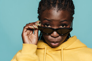 Young black woman wearing sunglasses looking at camera