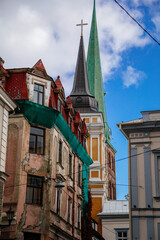 Obraz premium Riga, Latvia, 14 October 2021: St. James's Cathedral, Lutheran and Orthodox Church with bell tower, Northern Gothic Style with Red brick, recognizable medieval landmark at old town at sunny day