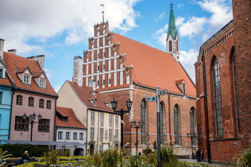 Riga, Latvia, 14 October 2021: St. John's Church, UNESCO heritage in Baltic states, Northern Gothic Style with Red brick and spire, recognizable medieval landmark at old town at sunny day