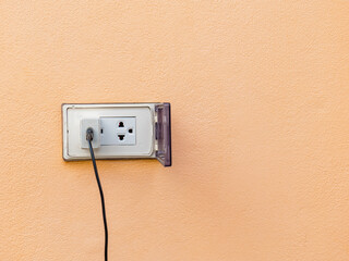 old white adapter There is a charging cable plugged in. With outdoor wall plugs, there is a cover...