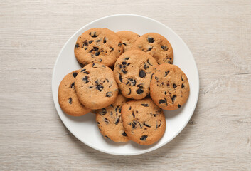Delicious chocolate chip cookies on white wooden table, top view