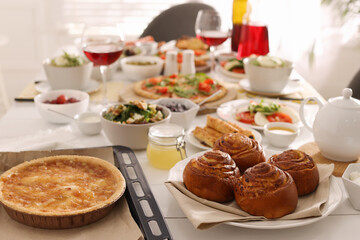 Many different dishes served on buffet table for brunch