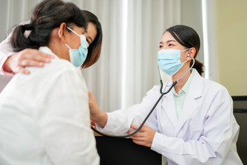 Asian female doctor talking to an elderly To maintain health with a smile, the concept is to take...