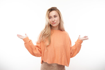 Smart blonde girl in casual shrugging hands thinks doubts, makes decision isolated on white studio background