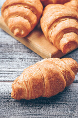 Freshly baked golden brown French croissants. Tasty baked croissants, warm buttery croissants, breakfast concept