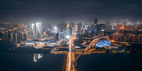 Aerial night view of Shengjing Theater and city buildings along Hun River in Shenyang, Liaoning,...