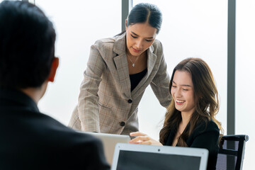 Two businessman women Asian company employees discussing at a company meeting.