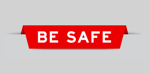 Red color inserted label with word be safe on gray background
