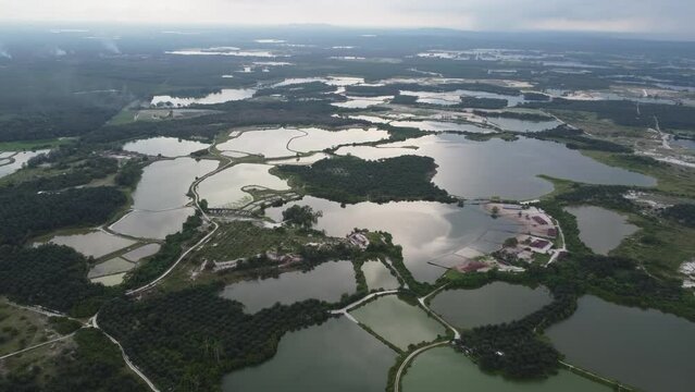 Aerial view reflection at abandoned tin mining lake and plantation at Kampar, Perak