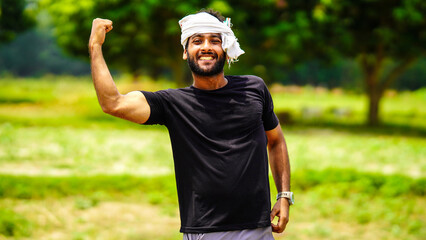 Fototapeta premium succeed indian young farmer boy with his land in village