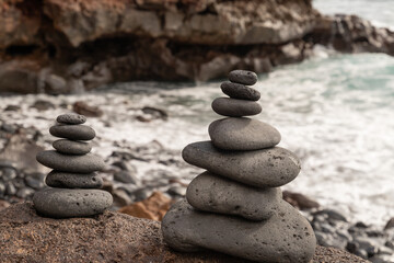Fototapeta na wymiar stacked black stones on a coast