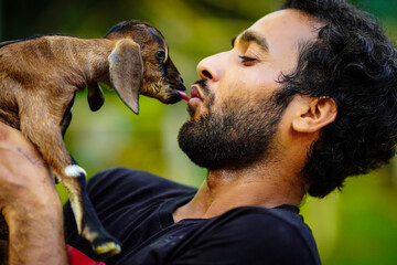 boy with cute baby goat pet animal
