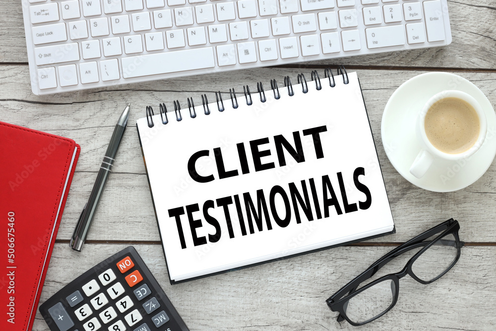 Poster clients testimonial. text on open notepad on wooden table near keyboard