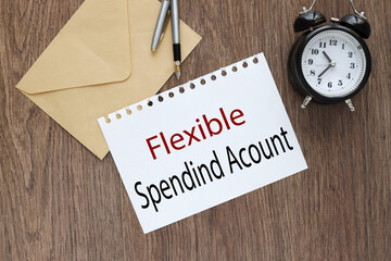 flexible spending account FSA on a table. text on white paper on craft block