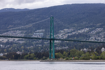 Lions Gate Bridge in a modern city on the West Coast of Pacific Ocean. Vancouver, British Columbia, Canada.