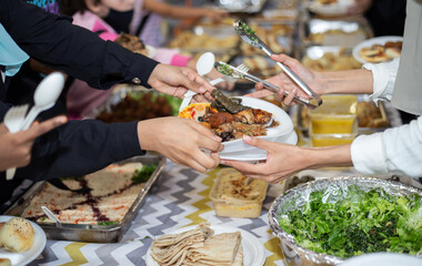 Selective focus shot of food being served on paper plate during hari raya party in Kuala Lumpur, Malaysia. 