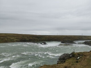 A stopp on the roadtrip in iceland with wild water river and rocks in the floss 