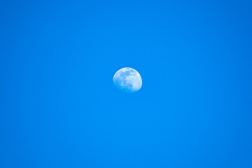 full moon in the blue sky