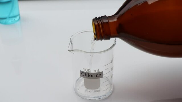 chlorine solution in glass, Chlorine is used to kill bacteria or to perform experiment in laboratory 