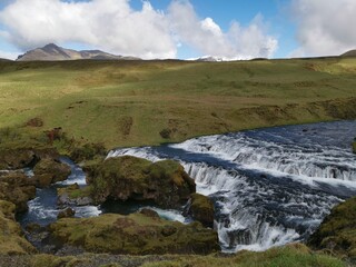 Wild waterfalls river fresh cold water outside iceland island europe travel sun green grass
