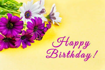 Happy Birthday! A beautiful bouquet of lilac and white daisies on a bright yellow background. Space for text.