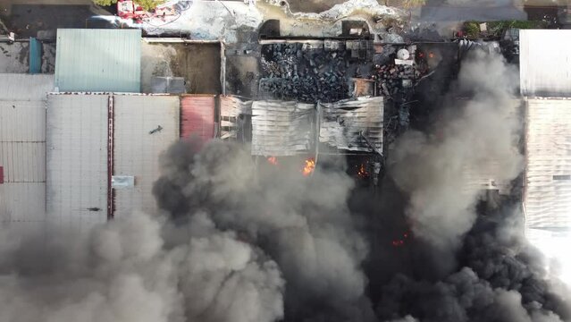 Aerial top down view fire smoke burning at factory