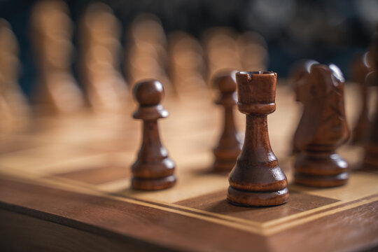 Wooden chess pieces on the board, selective focus image. Starting position of the game