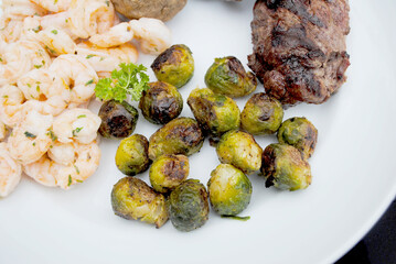Roasted Brussell Sprouts Served on a White Plate  as a Side Dish