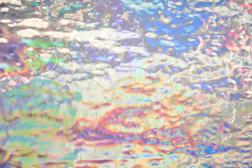 Holographic iridescent background wrinkled wavy abstract rainbow blurred background. Surface with multiple colors of webpunk in 90's style. High quality photo