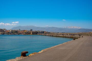 The view of the port of Heraklion with the Koules Fortress and mountains in the background
