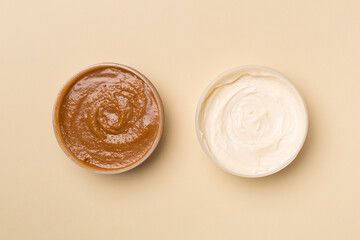 Natural scrub, body cream on color background, top view