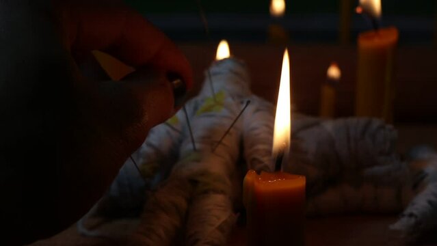 Candle light in the dark and curse doll, candle light ceremony