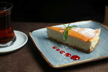 Delicious cheesecake with mint on the table