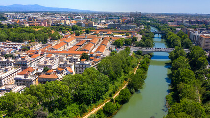 Fototapeta na wymiar Aerial view of the Tiber River in Rome, Italy, during a beautiful sunny summer day. In the foreground the Testaccio district.