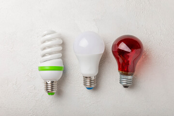 Electric light bulbs. the concept of energy efficiency. LED lamp vs incandescent lamp. Composition on a gray cement background. Use an economical and environmentally friendly light bulb concept.
