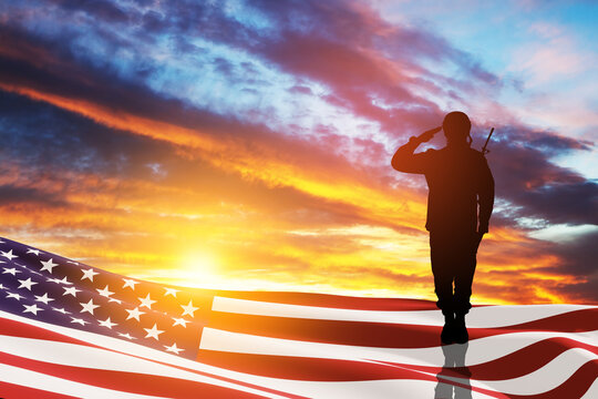 USA army soldier saluting with nation flag on a background of sunset or sunrise. Greeting card for Veterans Day, Memorial Day, Independence Day. America celebration. 3D-rendering.