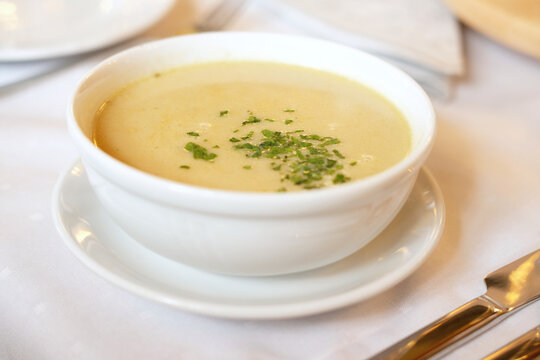 cream wild mushroom soup in white bowl -selective focus