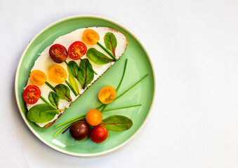 healthy colorful creative breakfast bread with tomato on plate