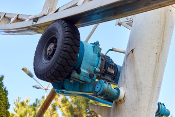 electric motor and rubber wheel for rotating the ferris wheel