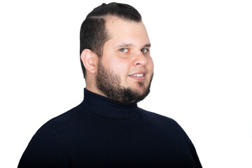 Obraz premium Young man headshot. He stands towards his left side and turns back his head to look at the camera with a smile