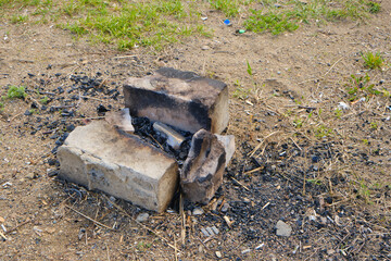 Remains extinguished bonfire and abandoned garbage, environmental pollution.