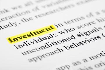 Investment Text Macro Shot Highlighted in Yellow Color On Printed Paper
