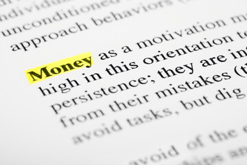 Money Text Macro Shot Highlighted in Yellow Color On Printed Paper