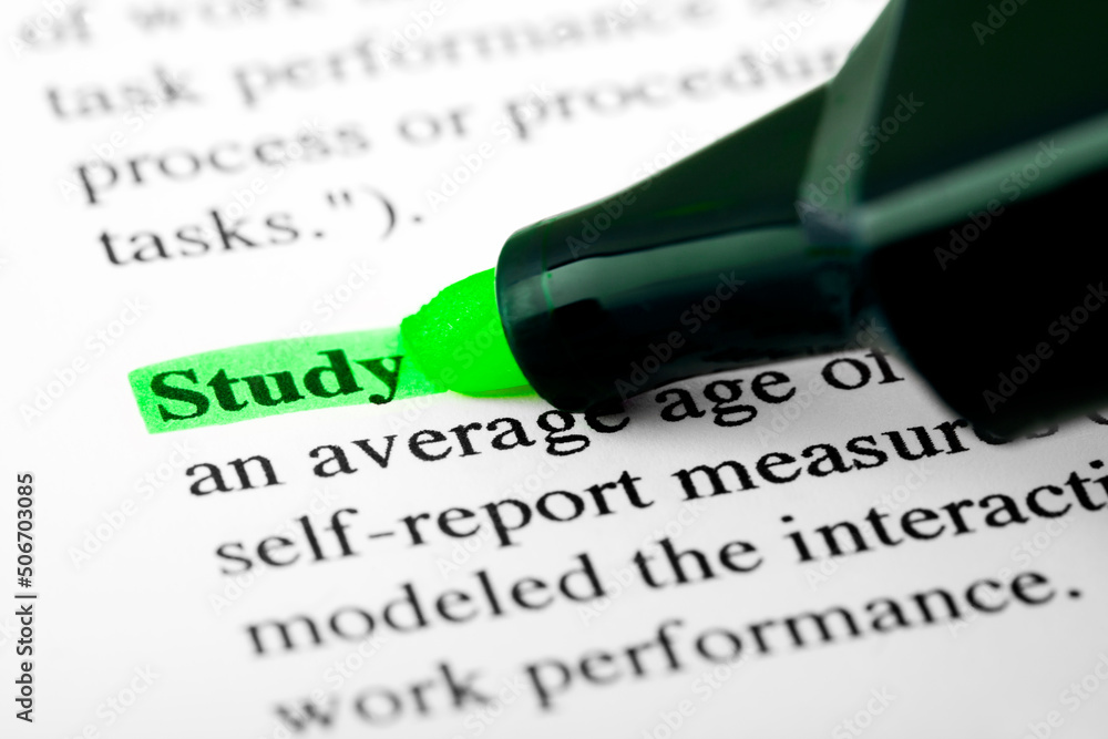 Poster study text macro shot highlighted with a highlighter in green color on printed paper